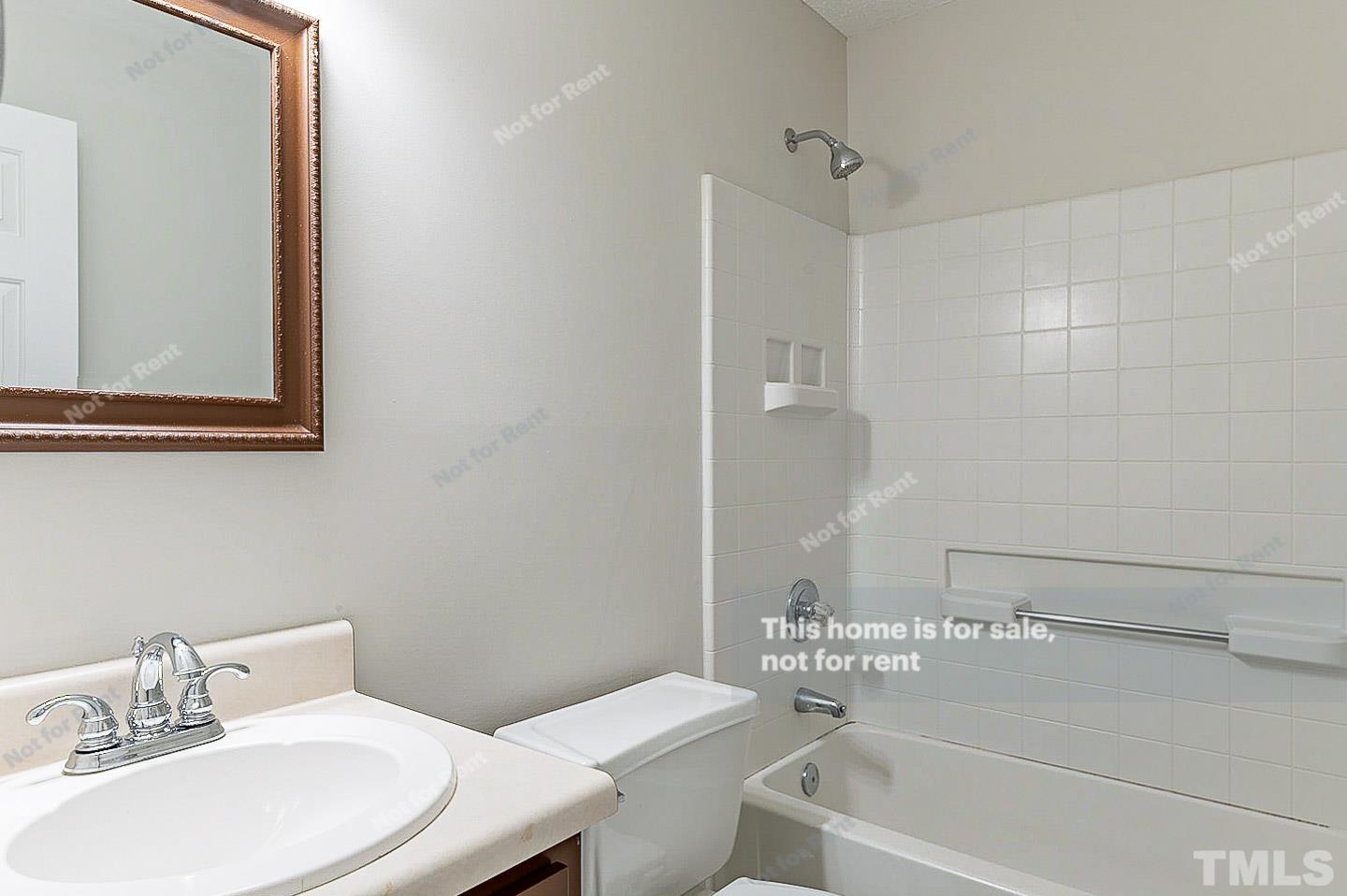 565 Darby Glen Lane Durham, NC 27713 - Photo 16 of 18 a bathroom with a sink and a mirror