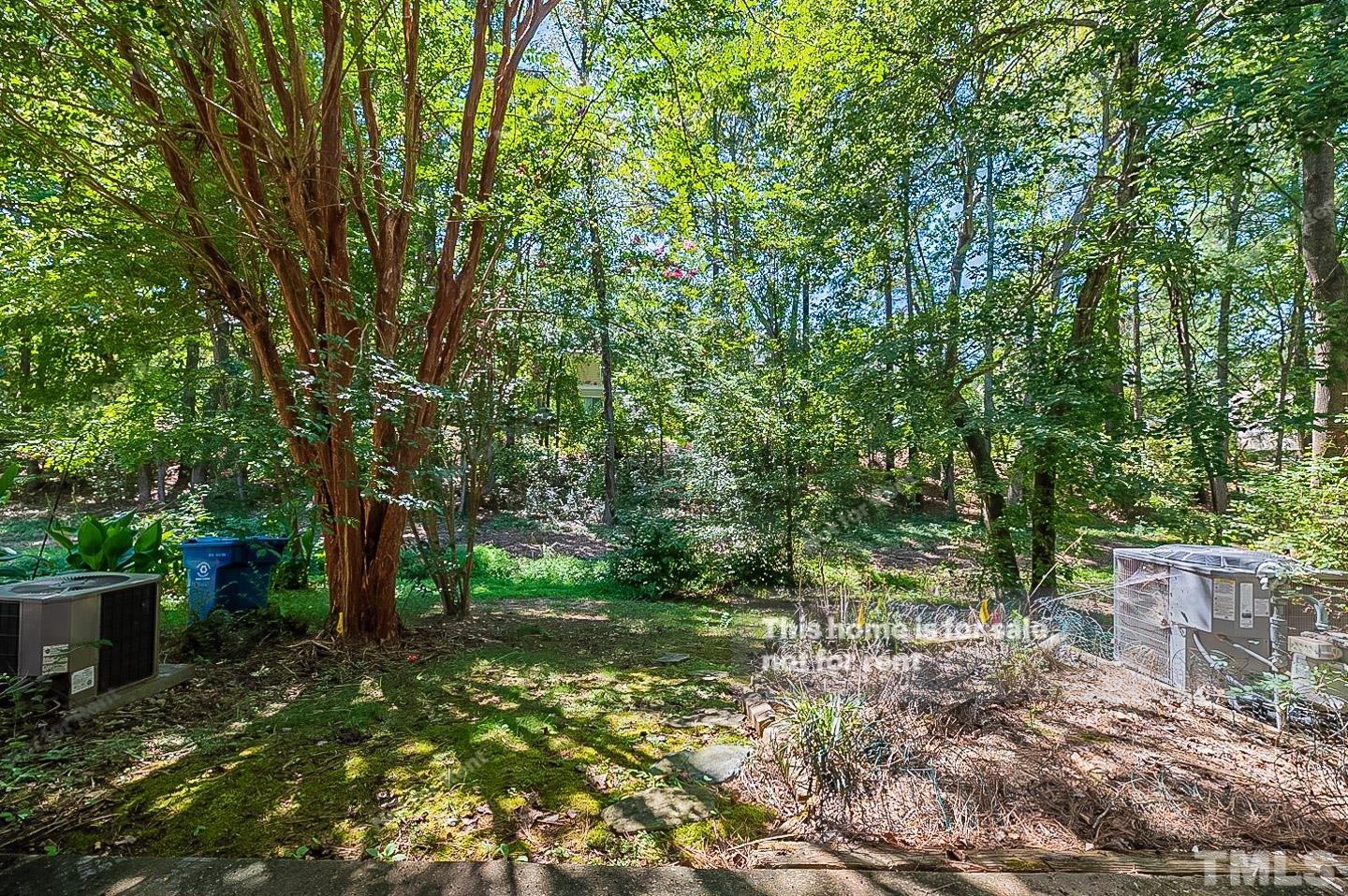 565 Darby Glen Lane Durham, NC 27713 - Photo 17 of 18 a backyard of a house with lots of green space