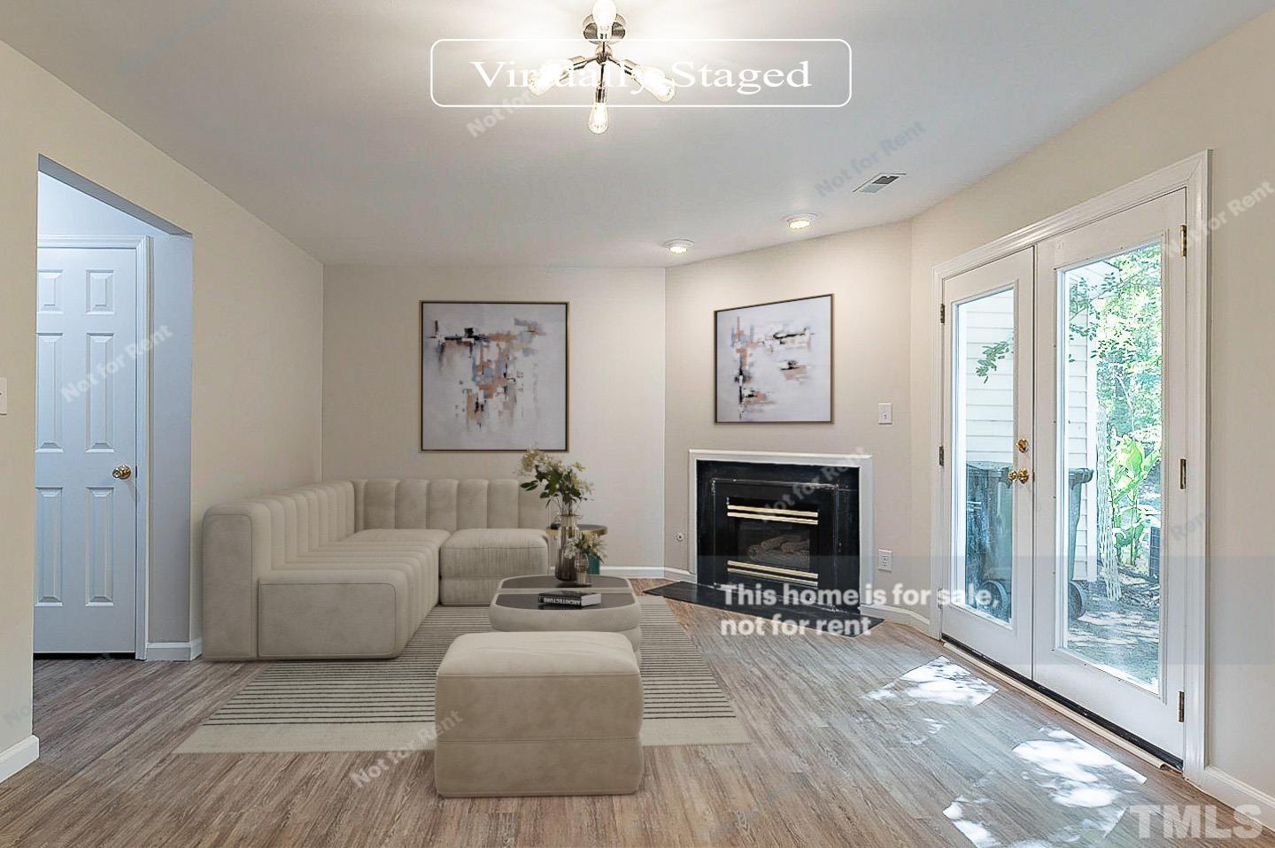 565 Darby Glen Lane Durham, NC 27713 - Photo 2 of 18 a living room with furniture a fireplace and a floor to ceiling window