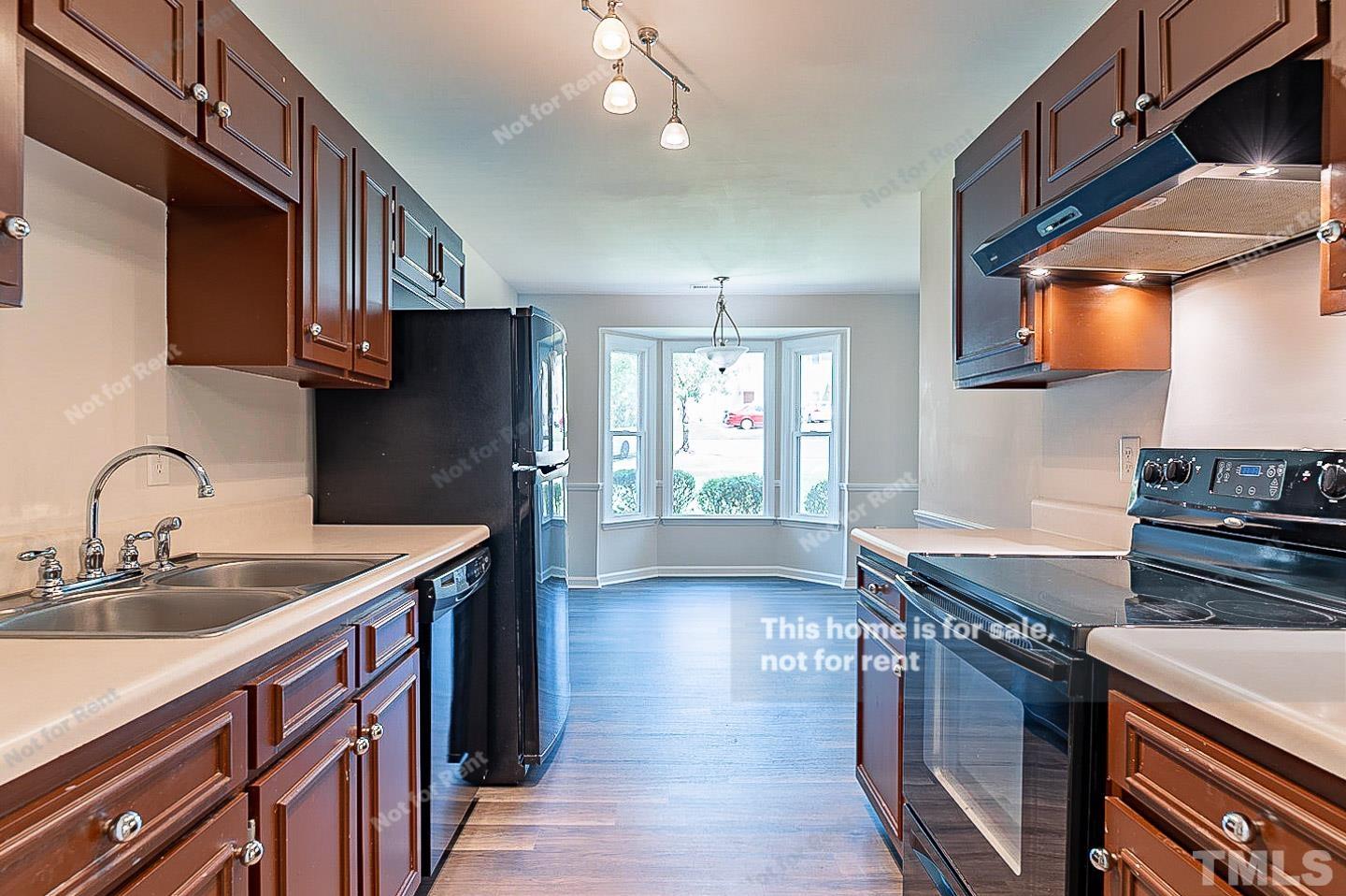 565 Darby Glen Lane Durham, NC 27713 - Photo 6 of 18 a kitchen with stainless steel appliances granite countertop a sink stove and cabinets