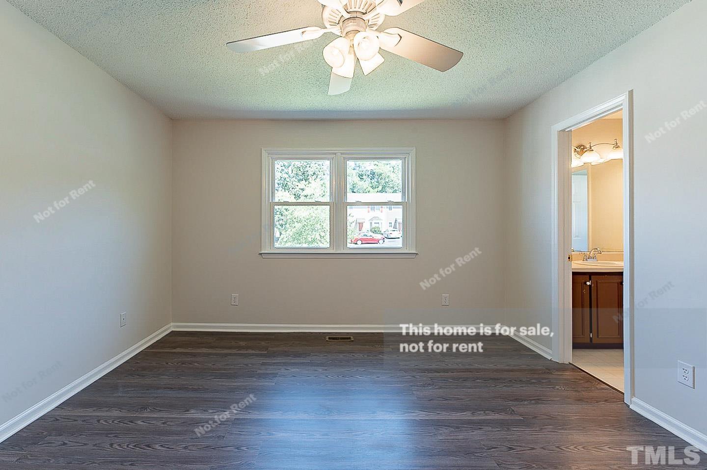 565 Darby Glen Lane Durham, NC 27713 - Photo 10 of 18 an empty room with wooden floor chandelier fan and windows