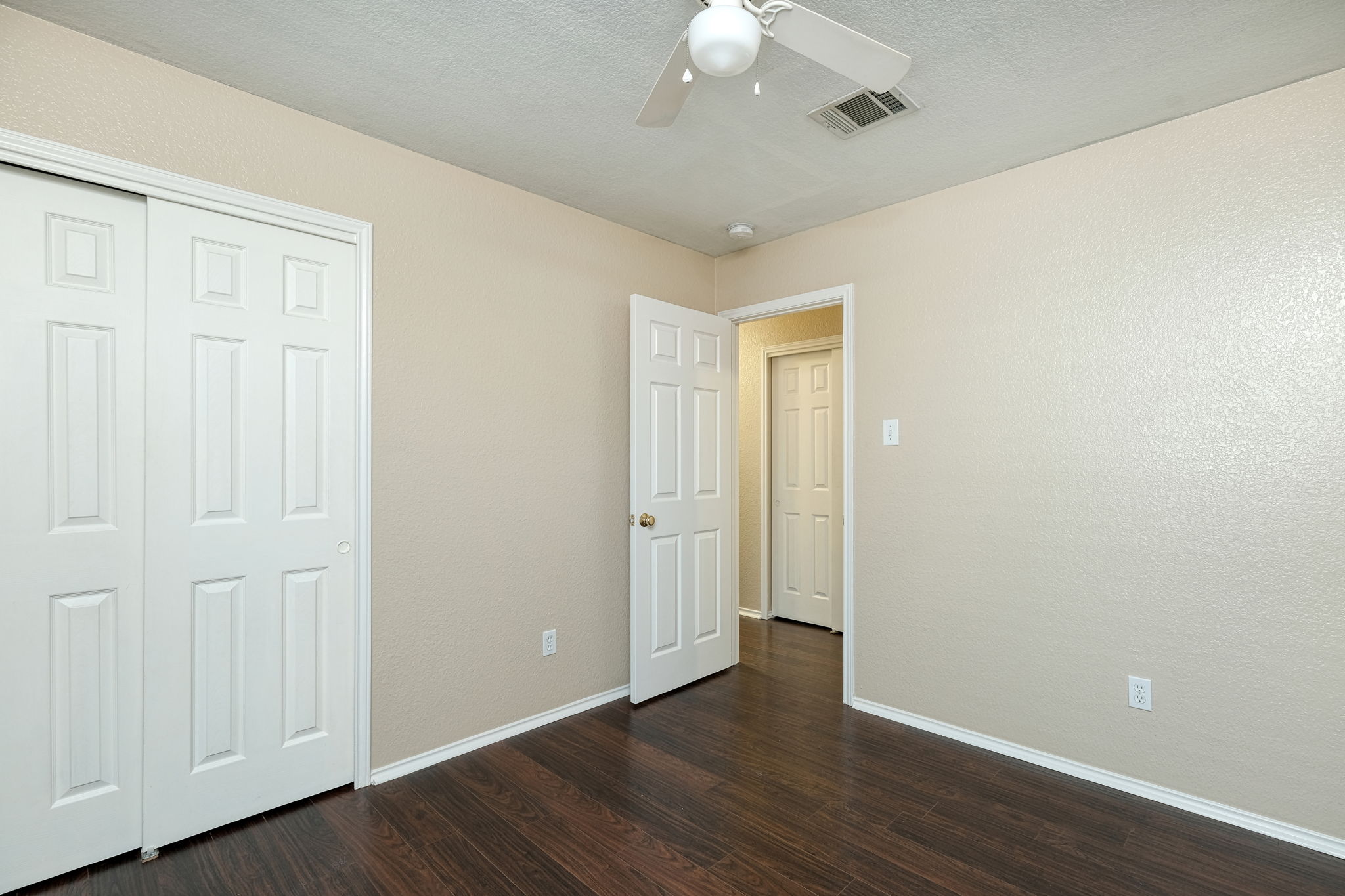124 Hunter Rex Way Kyle, TX 78640 - Photo 11 of 14 Room featuring dark wood-finish flooring and light-toned walls
