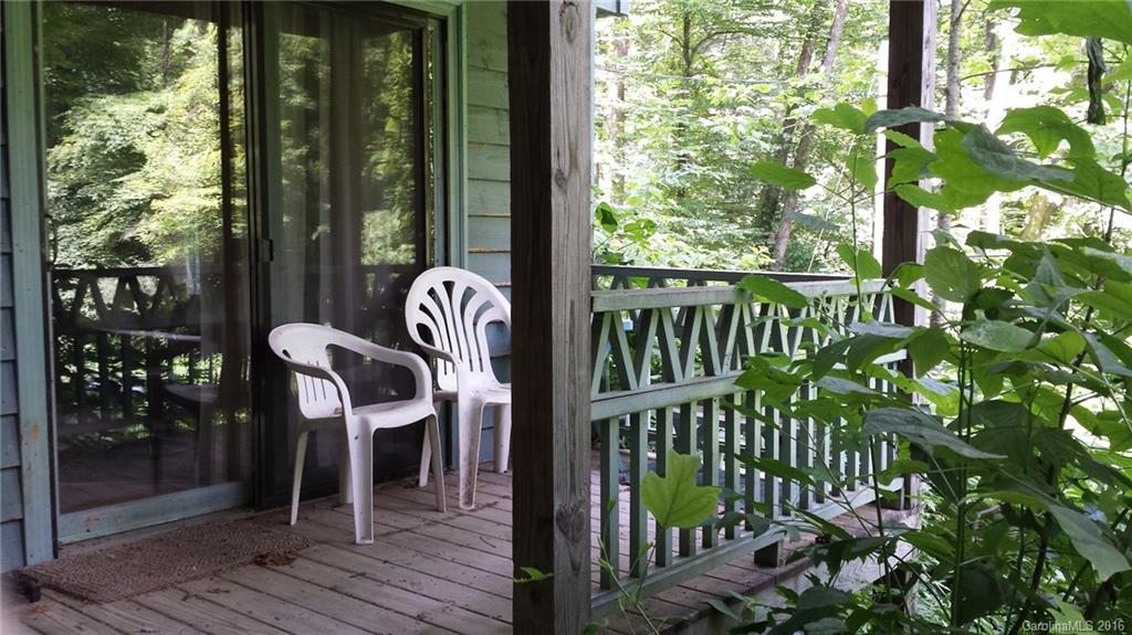 1083 Big Creek Road Marshall, NC 28753 - Photo 3 of 23 a view of a balcony with chairs and wooden floor
