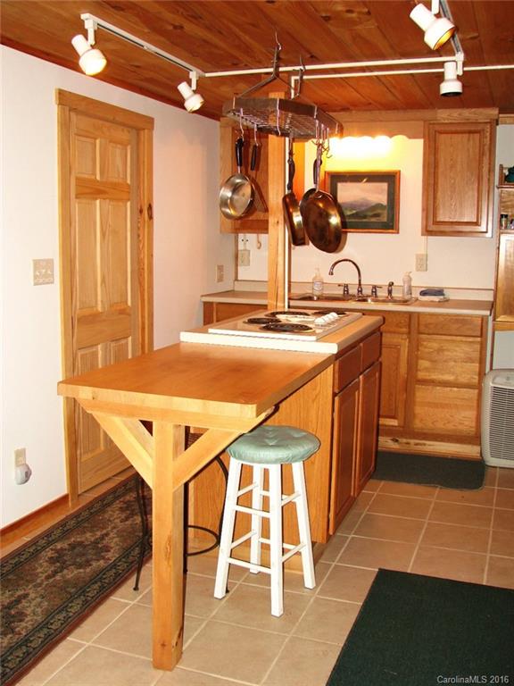 1083 Big Creek Road Marshall, NC 28753 - Photo 5 of 23 a kitchen with a sink a counter top space and a window