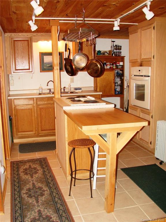 1083 Big Creek Road Marshall, NC 28753 - Photo 6 of 23 a dinning table chair in the kitchen next to a window