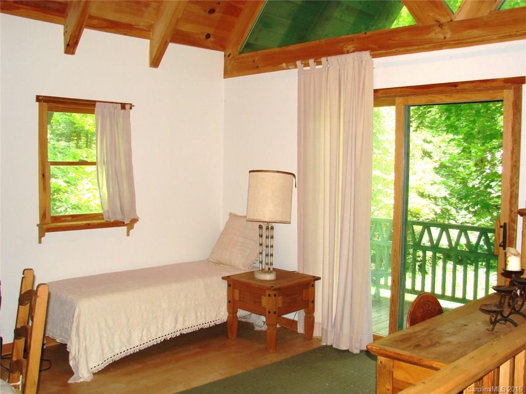 1083 Big Creek Road Marshall, NC 28753 - Photo 10 of 23 a bedroom with a bed and large window
