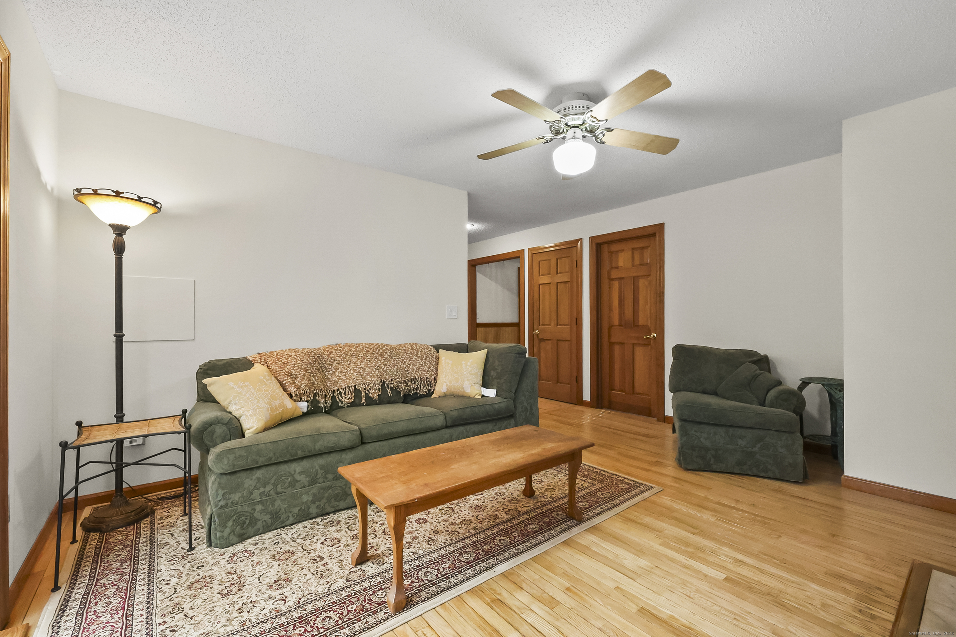 111 Bascom Road Lebanon, CT 06249 - Photo 18 of 30 a living room with furniture and a chandelier