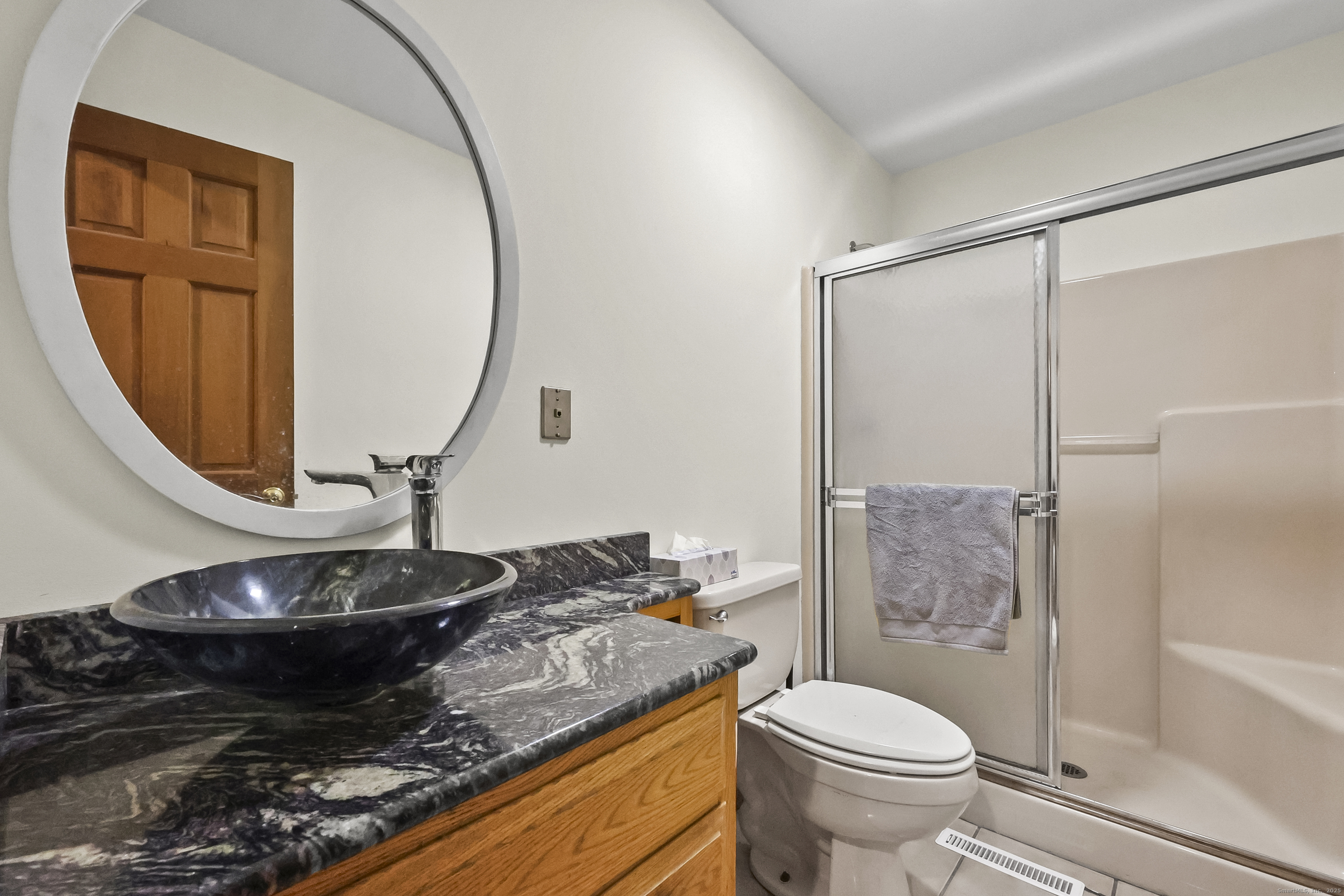 111 Bascom Road Lebanon, CT 06249 - Photo 20 of 30 a bathroom with a granite countertop sink toilet and a mirror