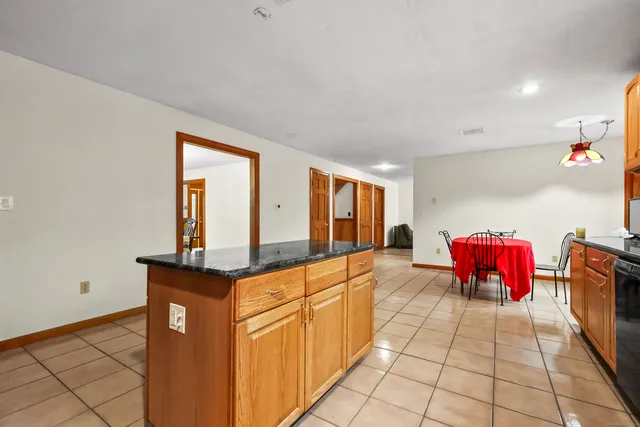 a kitchen with stainless steel appliances granite countertop a sink and a wooden cabinets