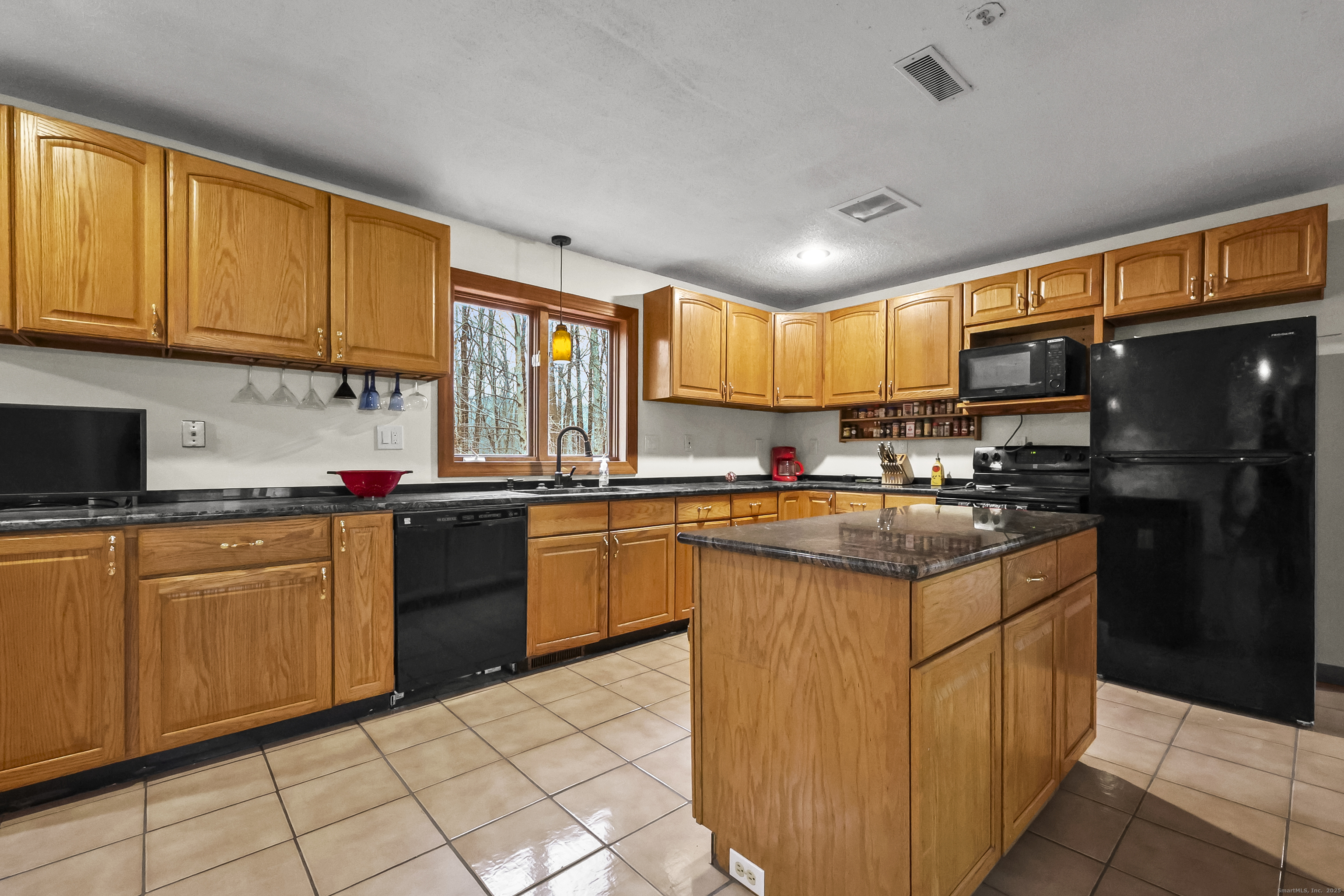 111 Bascom Road Lebanon, CT 06249 - Photo 22 of 30 a kitchen with stainless steel appliances granite countertop a stove sink and cabinets