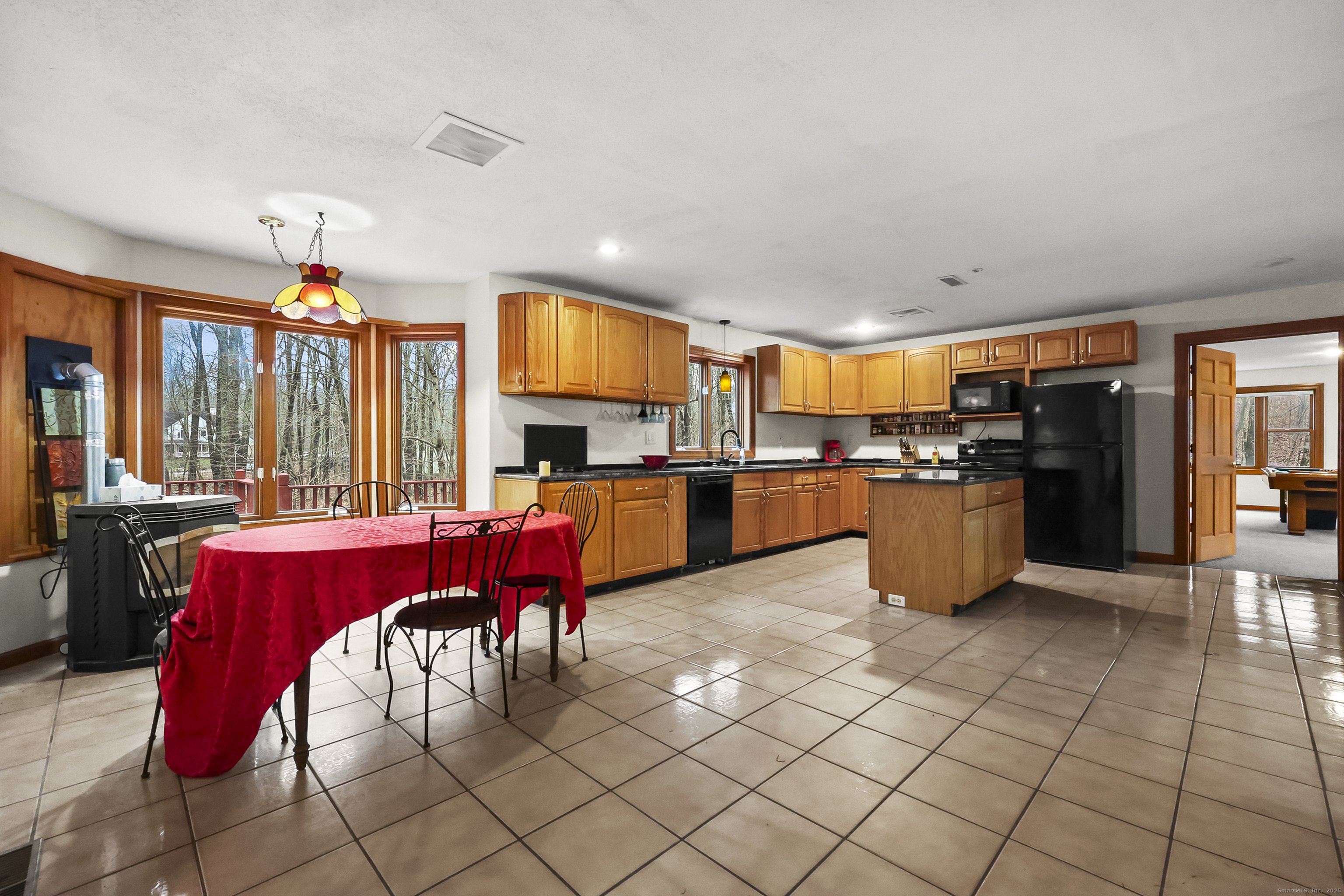 111 Bascom Road Lebanon, CT 06249 - Photo 23 of 30 a kitchen with stainless steel appliances kitchen island granite countertop a stove a sink dishwasher and a refrigerator