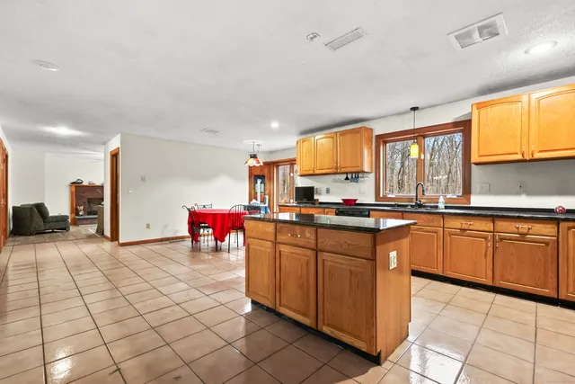 a kitchen with stainless steel appliances granite countertop a sink and cabinets