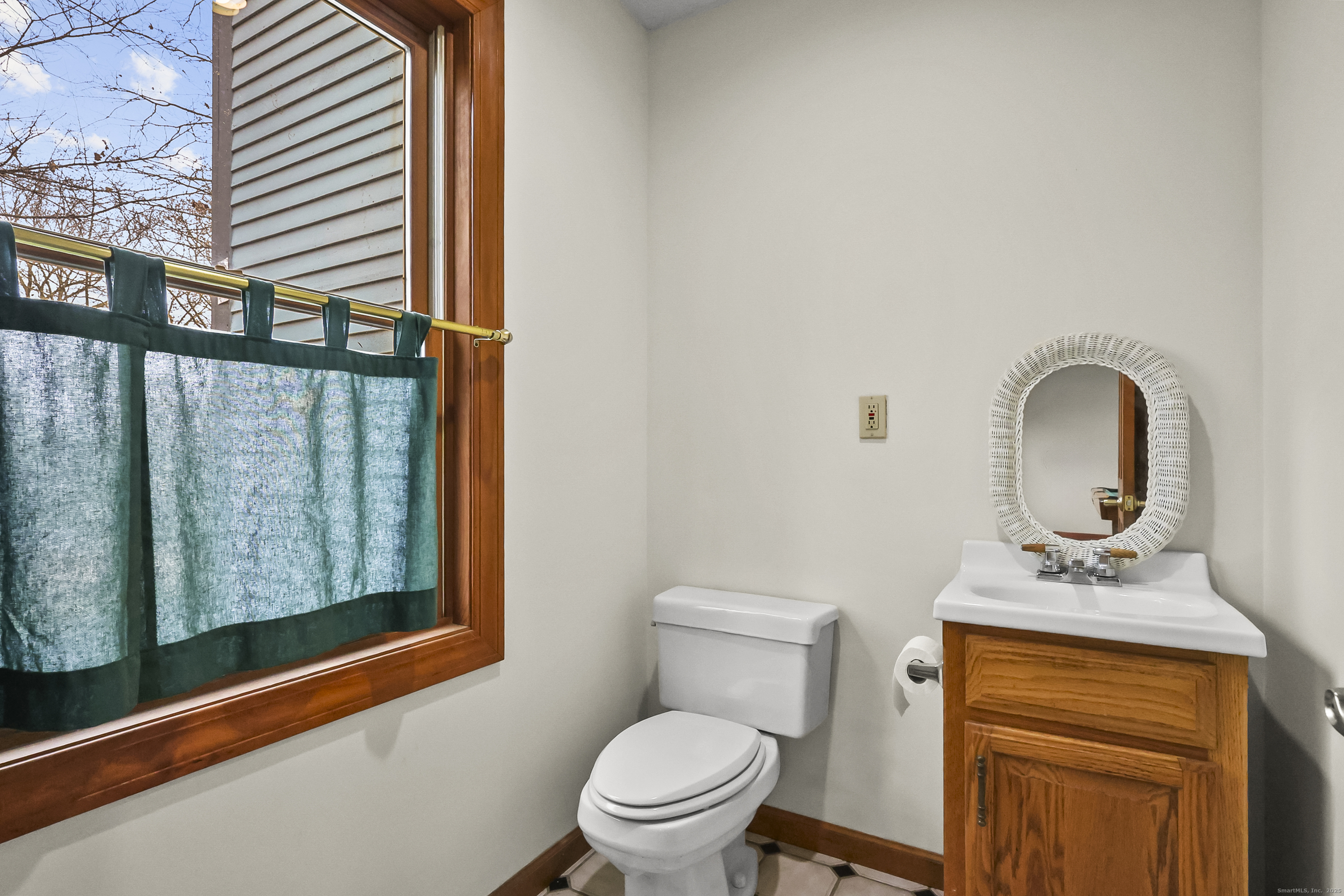 111 Bascom Road Lebanon, CT 06249 - Photo 27 of 30 a bathroom with a toilet sink and mirror