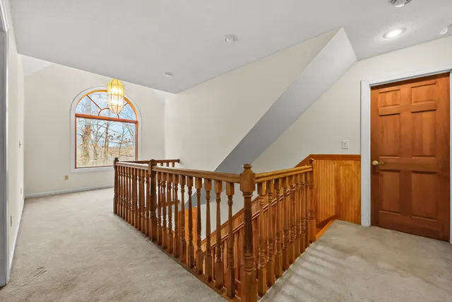 a view of entryway with wooden floor and windows