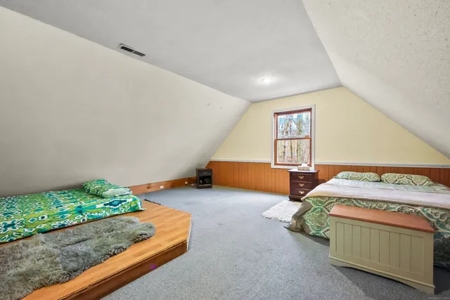 a bedroom with bed and window