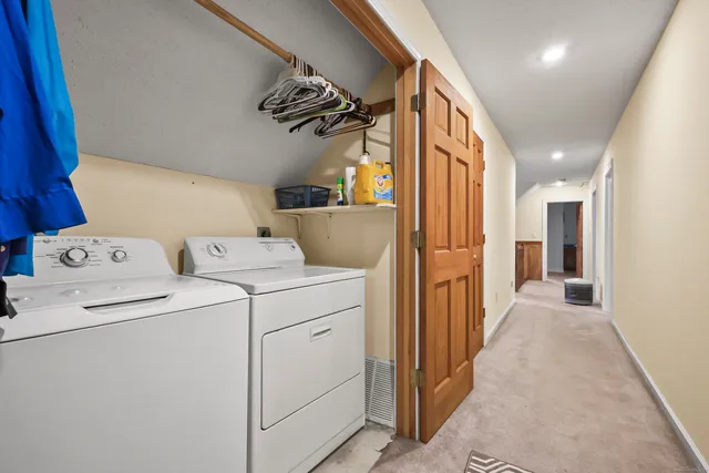 a view of storage and utility room with washer and dryer