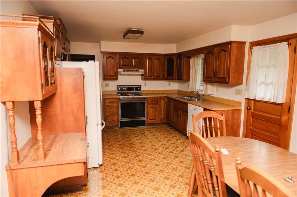 608 Edgewood Drive Apollo, PA 15613 - Photo 11 of 40 a kitchen with stainless steel appliances granite countertop a stove a sink and a refrigerator
