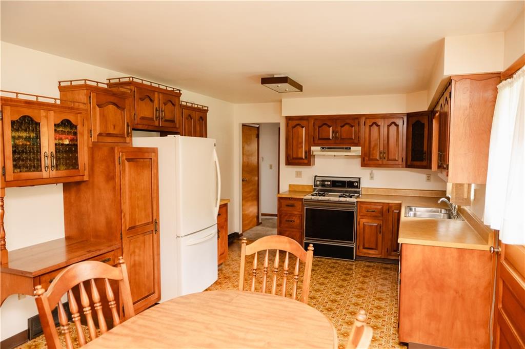 608 Edgewood Drive Apollo, PA 15613 - Photo 7 of 40 a kitchen with stainless steel appliances kitchen island granite countertop a refrigerator and a stove top oven