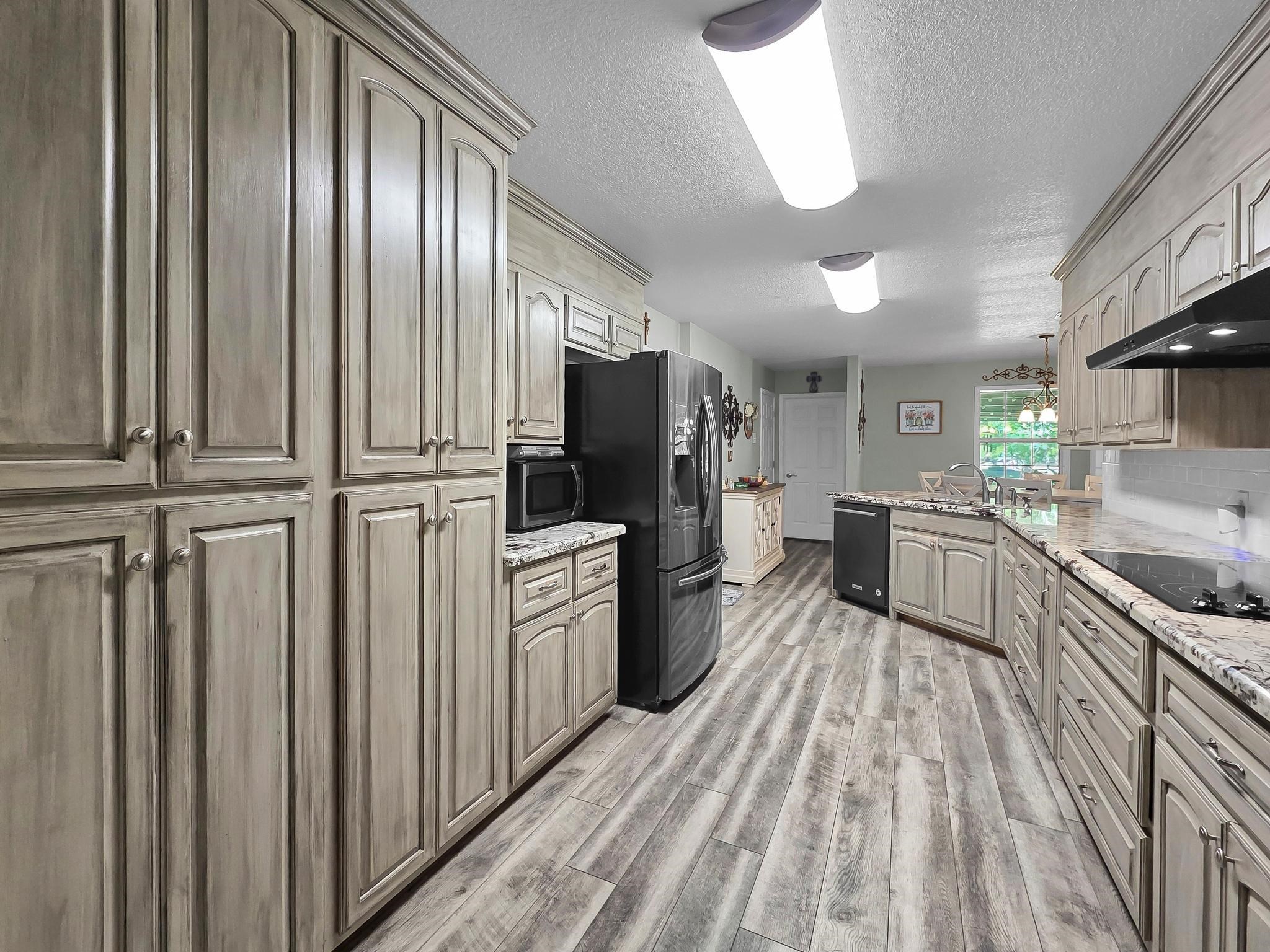 738 Parish Road Orange, TX 77632 - Photo 25 of 45 a kitchen with stainless steel appliances granite countertop a refrigerator a stove and a sink