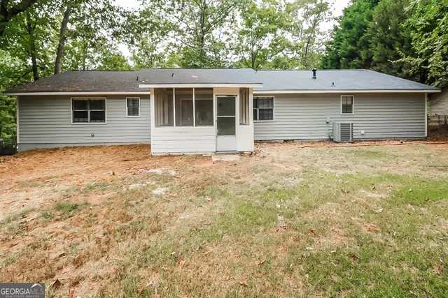 a house that has a large tree in front of it
