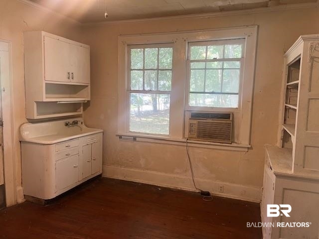 321 Grant Street Chickasaw, AL 36611 - Photo 9 of 13 Unfurnished dining area with dark wood-style floors, ornamental molding, and cooling unit