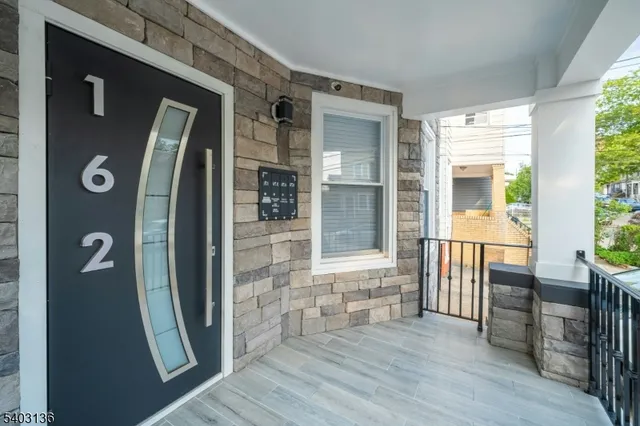 a view of a hallway with wooden floor and windows