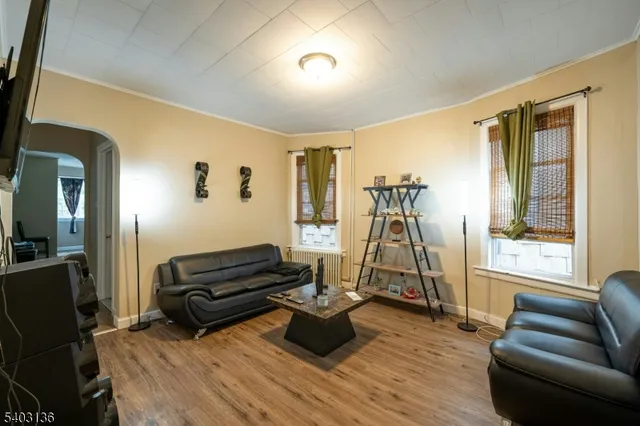 a living room with furniture gym equipment and a window