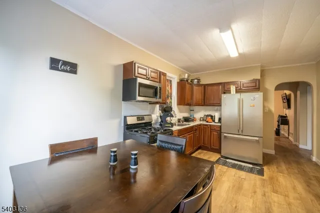 a kitchen with stainless steel appliances granite countertop a sink refrigerator and microwave