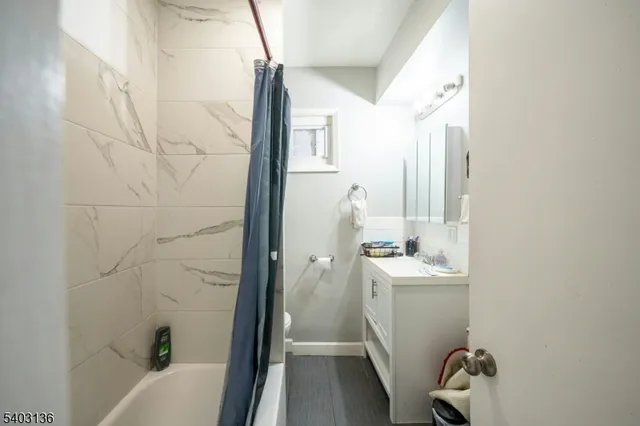 a bathroom with a sink a window and tub