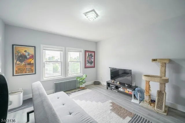 a bedroom with furniture and a flat screen tv