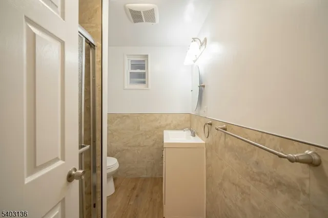a bathroom with a shower and a mirror