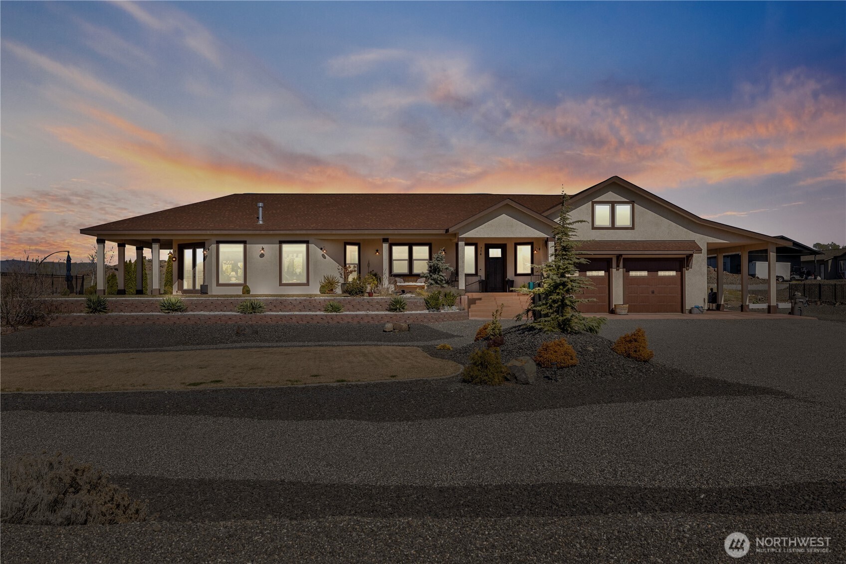 714 Sunset Boulevard Mattawa, WA 99349 - Photo 1 of 40 a front view of a house with a garden