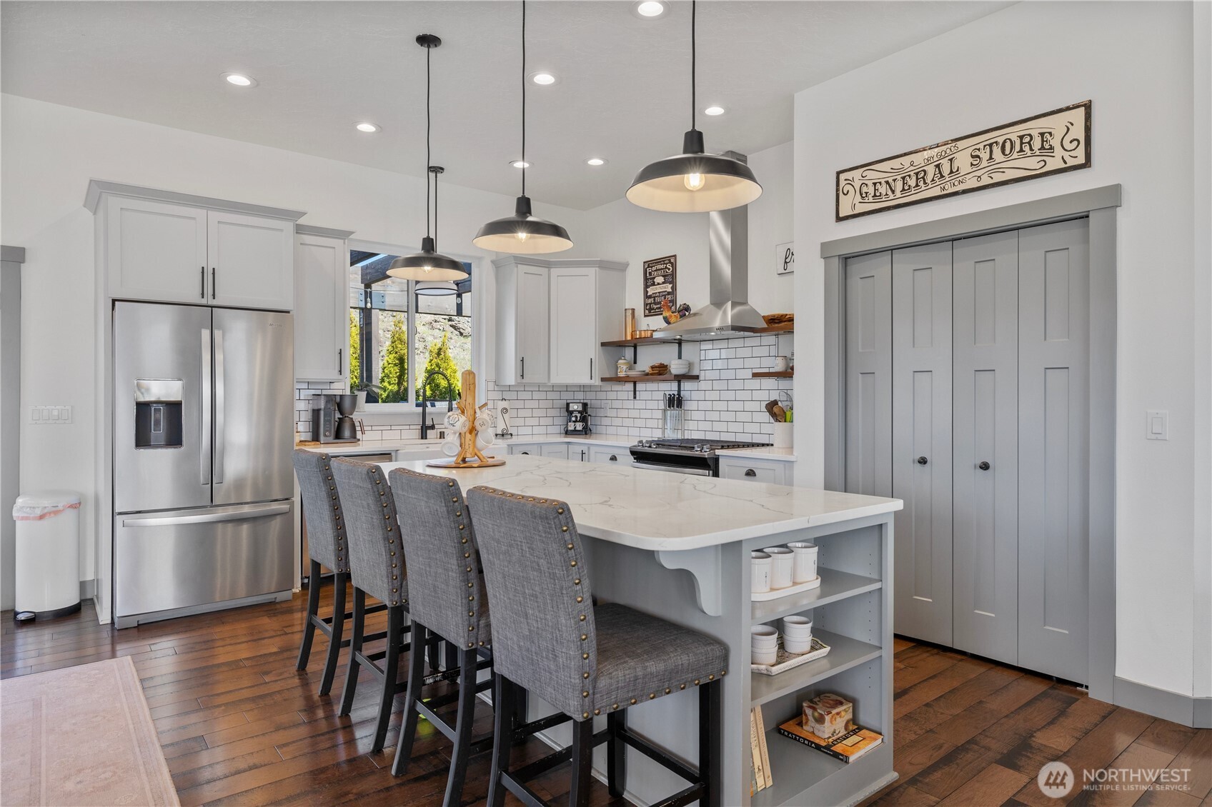 714 Sunset Boulevard Mattawa, WA 99349 - Photo 11 of 40 a kitchen with stainless steel appliances a dining table chairs refrigerator and microwave