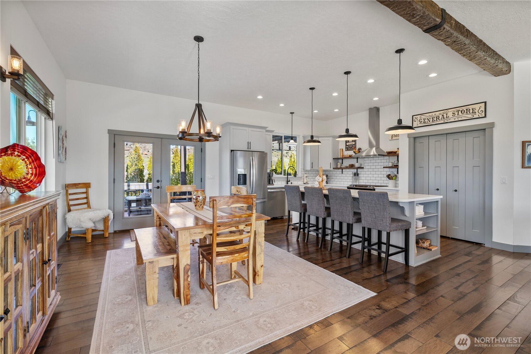 714 Sunset Boulevard Mattawa, WA 99349 - Photo 14 of 40 a view of a dining room and livingroom with furniture wooden floor a rug a fireplace and a chandelier