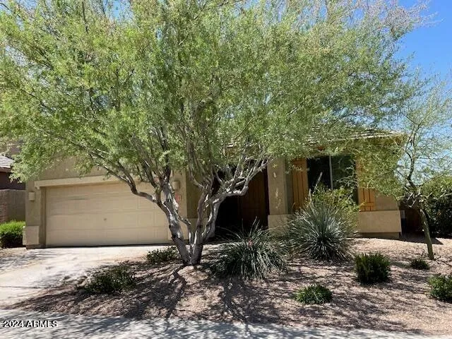 a tree in front of a house