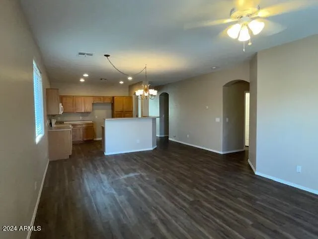 a view of a kitchen with a sink and dishwasher with wooden floor