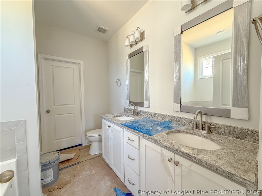 809 Union Street Raeford, NC 28376 - Photo 6 of 9 a bathroom with a granite countertop sink and a mirror