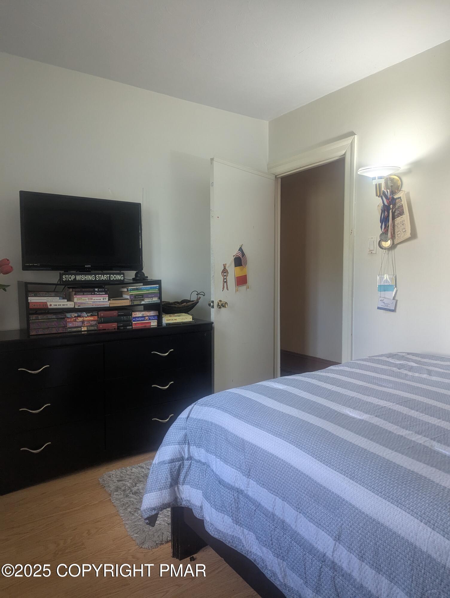 593 Pardee Street Hazleton, PA 18201 - Photo 12 of 17 a bedroom with a bed and a flat screen tv