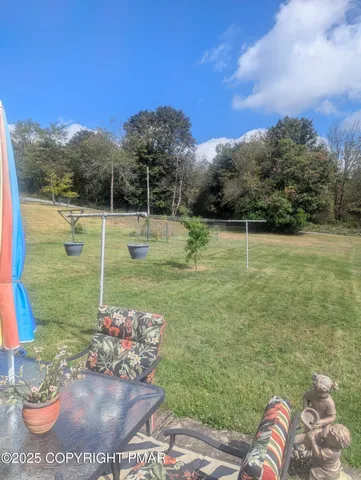 a balcony with table and chairs potted plants with sky view