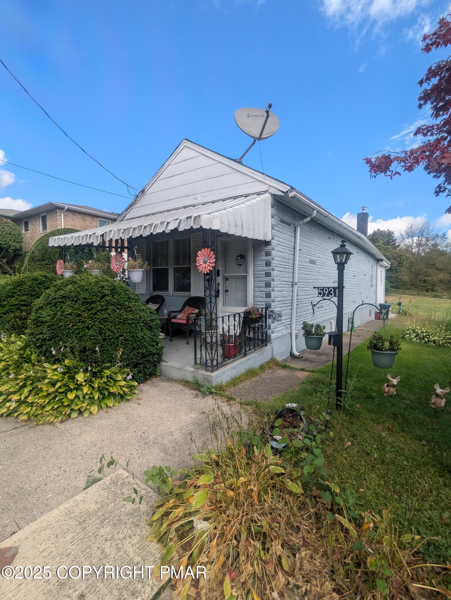 593 Pardee Street Hazleton, PA 18201 - Photo 17 of 17 a view of a backyard with table and chairs under an umbrella