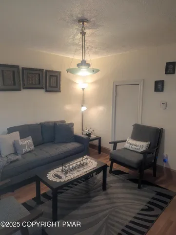 a living room with furniture a window and a table