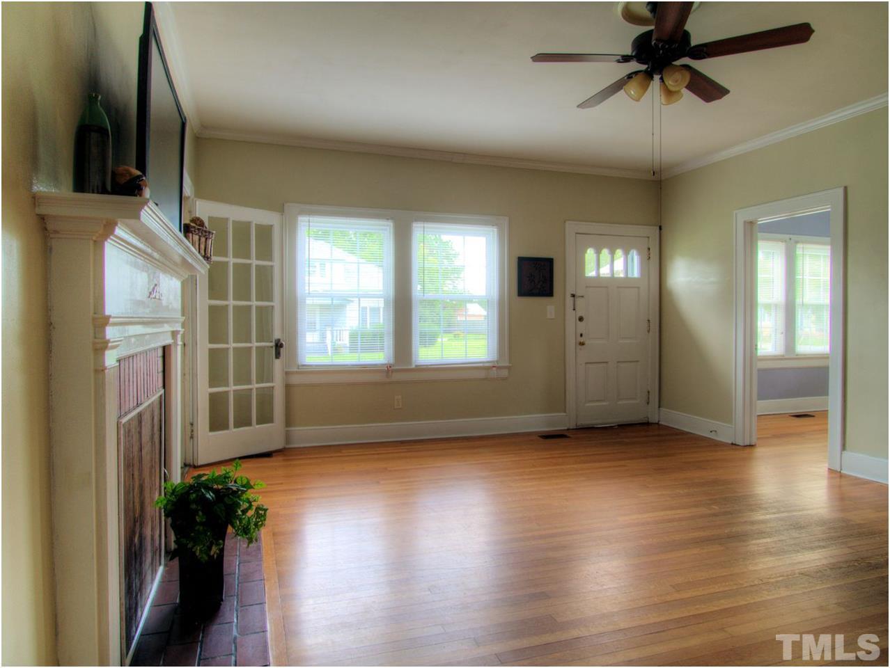 6708 Dwight Rowland Road Willow Spring, NC 27592 - Photo 3 of 20 Enter into a large living room, with French doors, fireplace space (not operable currently), and beautiful original hardwood floors!