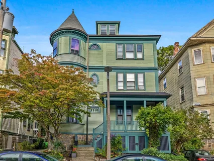 a front view of a residential apartment building with a yard