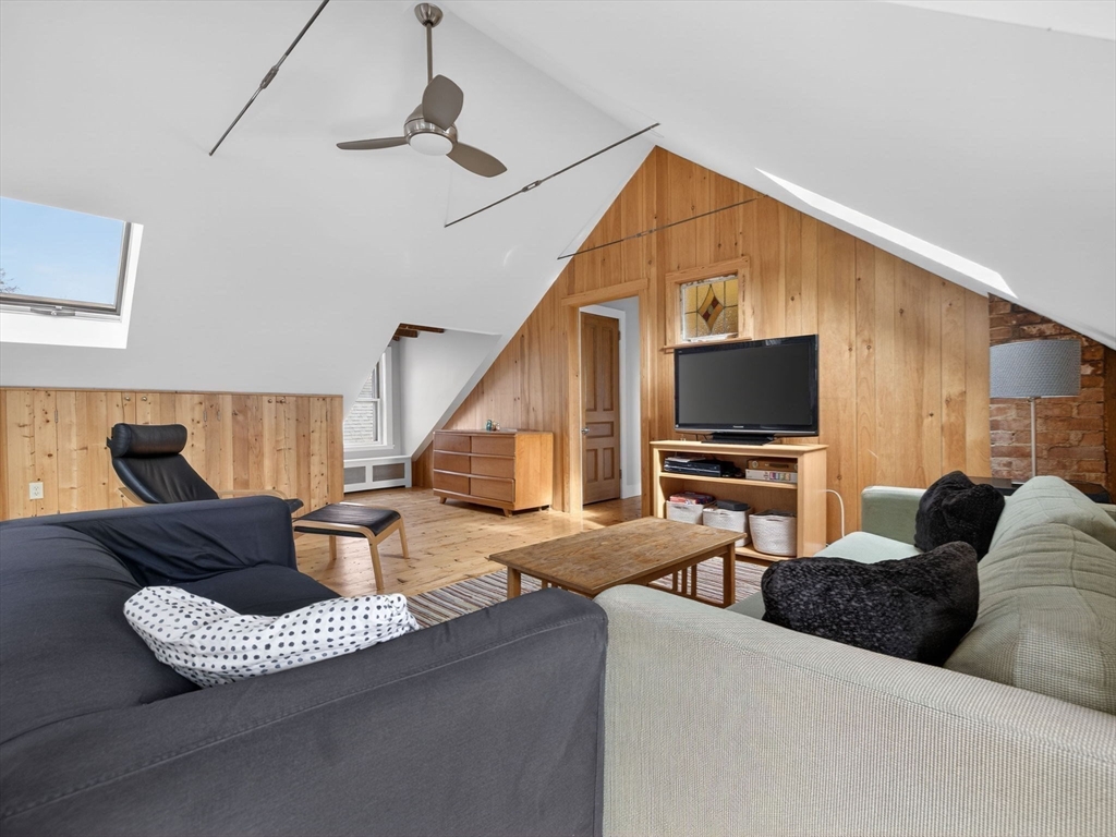25 Danforth Street, Unit 3 Boston, MA 02130 - Photo 21 of 38 a living room with furniture and a flat screen tv