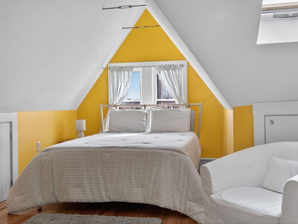 25 Danforth Street, Unit 3 Boston, MA 02130 - Photo 23 of 38 a bedroom with a bed and wooden floor