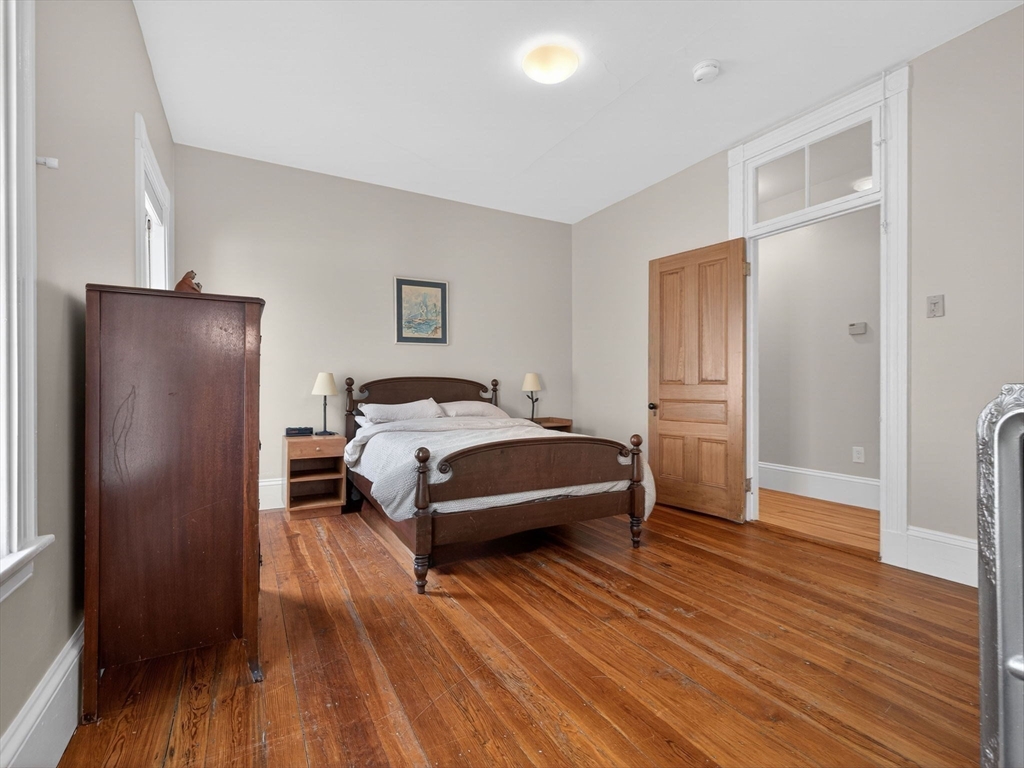 25 Danforth Street, Unit 3 Boston, MA 02130 - Photo 32 of 38 a bedroom with a bed and wooden floor