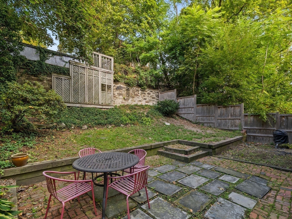 25 Danforth Street, Unit 3 Boston, MA 02130 - Photo 34 of 38 a backyard of a house with table and chairs