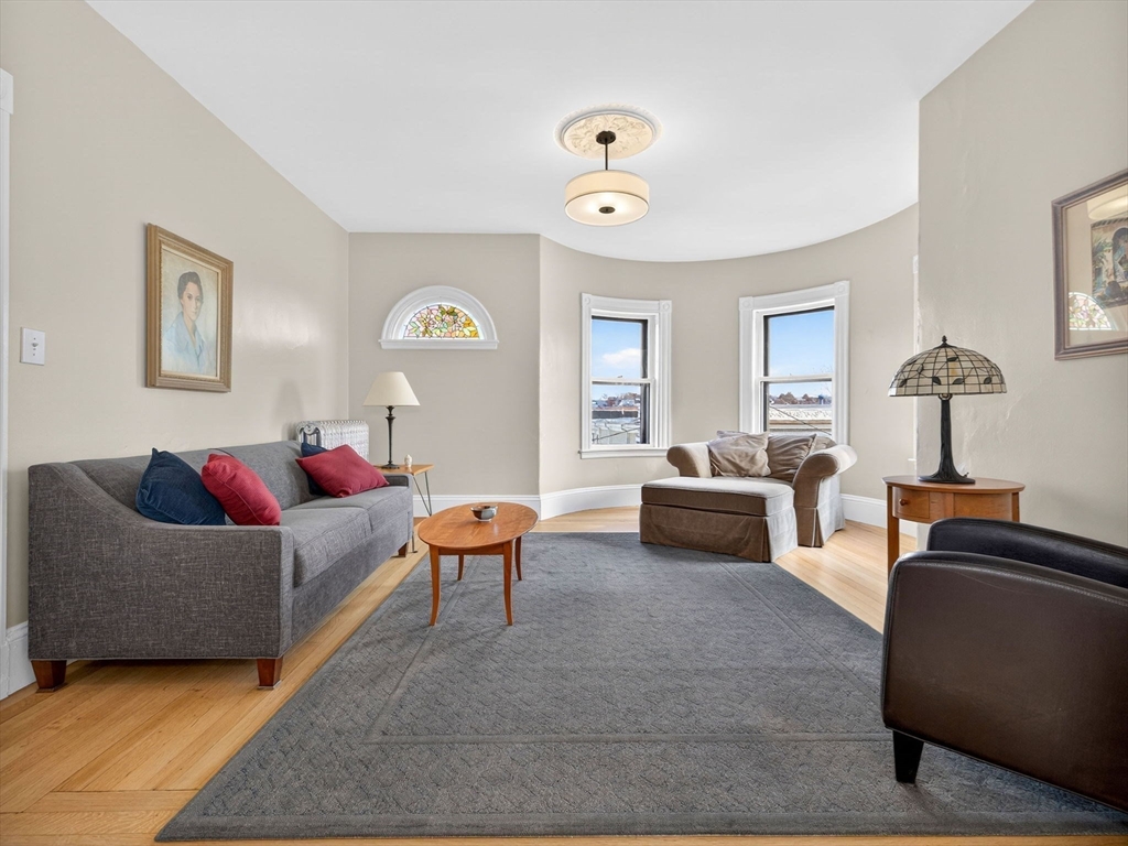 25 Danforth Street, Unit 3 Boston, MA 02130 - Photo 4 of 38 a living room with furniture and a chandelier