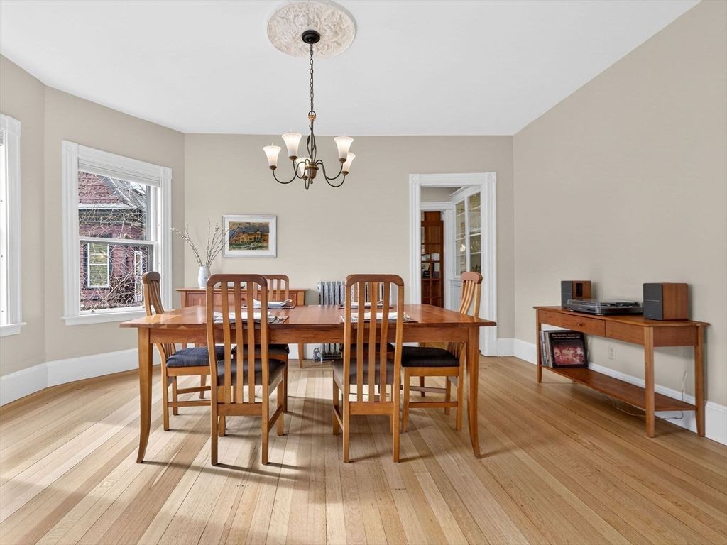 25 Danforth Street, Unit 3 Boston, MA 02130 - Photo 9 of 38 a view of a dining room with furniture a chandelier and wooden floor
