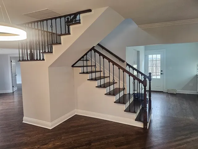 a view of entryway and hall with wooden floor
